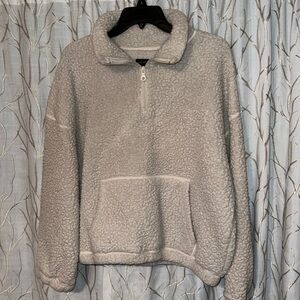 Cream in color pull over sweater. Half zip up.